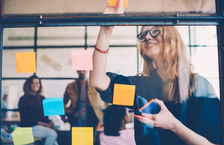 Young woman brainstorming with colleagues 